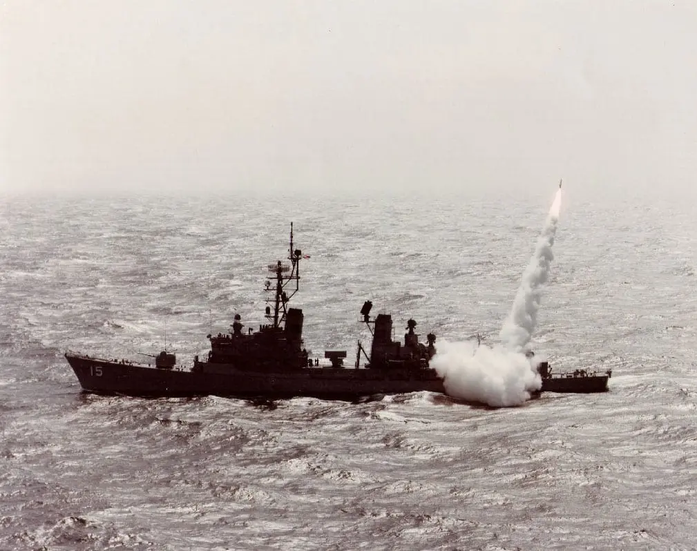 A boat with a missile in the ocean.